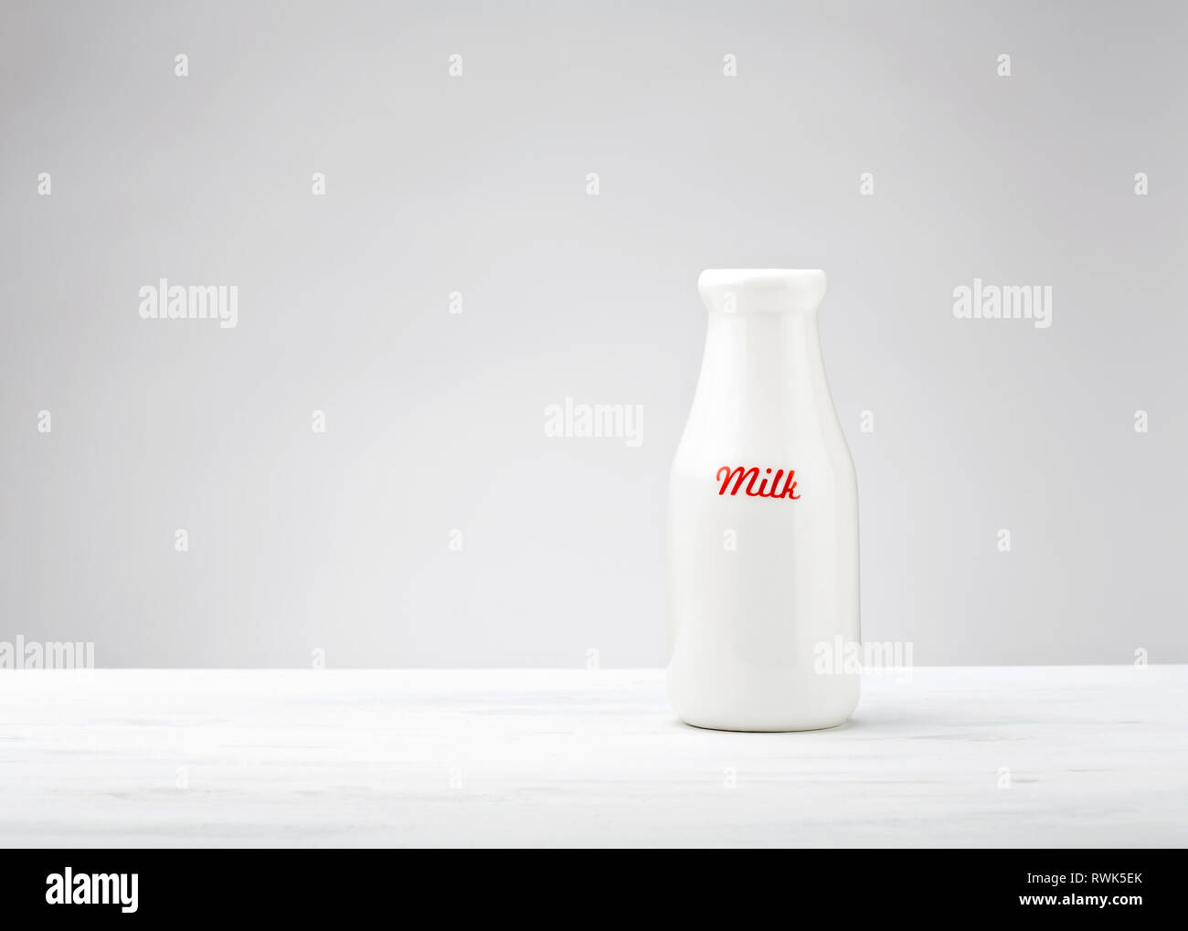 A white bottle of Milk over a light colored background Stock Photo