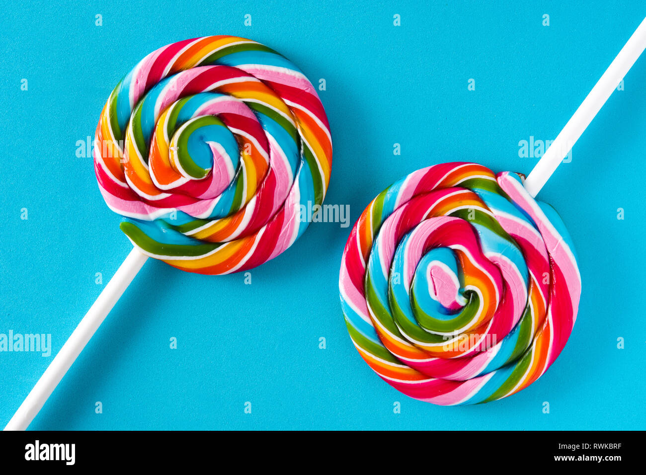 Colorful lollipops on blue background Stock Photo