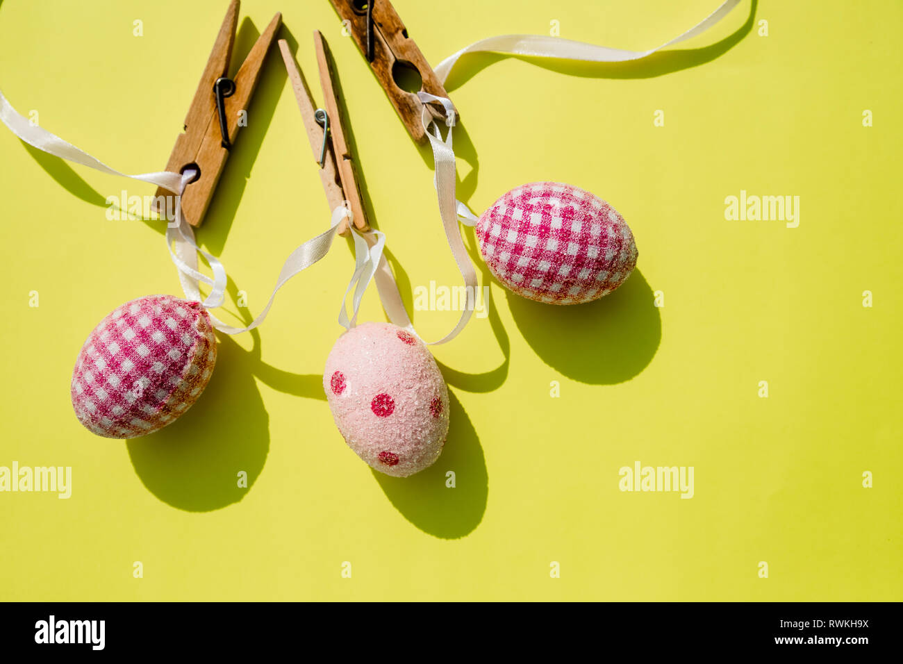 Eggs painted various patterns for Easter holiday. Yellow bright background, copy space, minimalistic concept.Stylish Candy color easter eggs .Spring Stock Photo