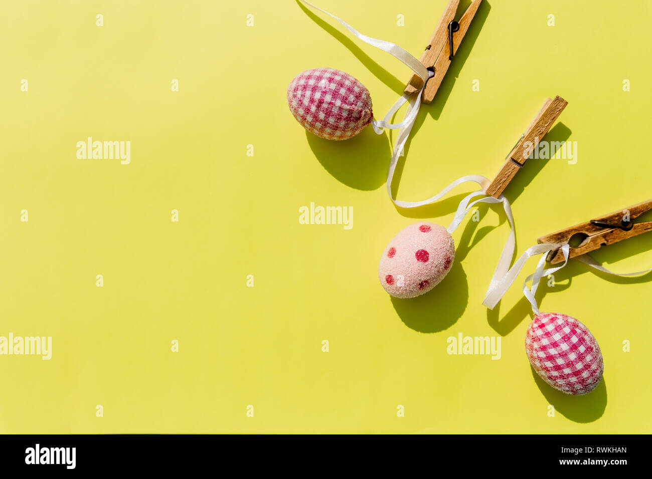 Eggs painted various patterns for Easter holiday. Yellow bright background, copy space, minimalistic concept.Stylish Candy color easter eggs .Spring Stock Photo