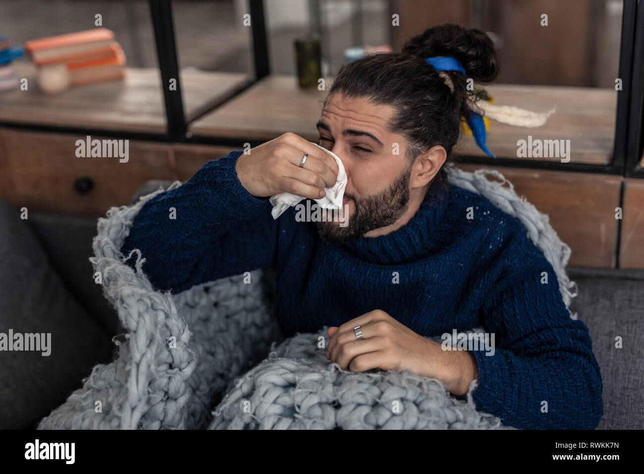 Unhappy young man suffering from running nose Stock Photo
