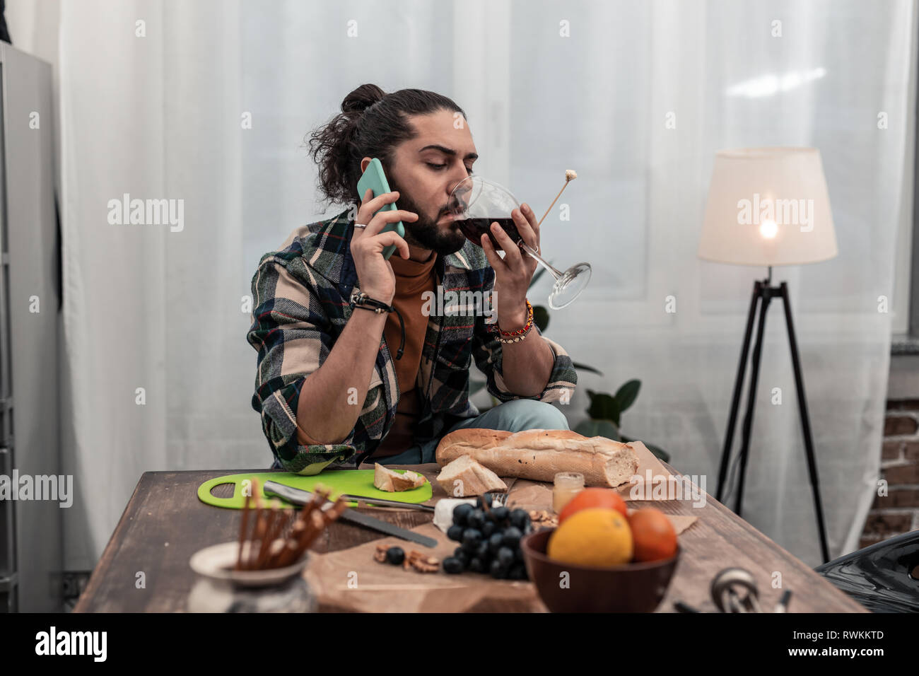 Nice pleasant having taking a sip of wine Stock Photo
