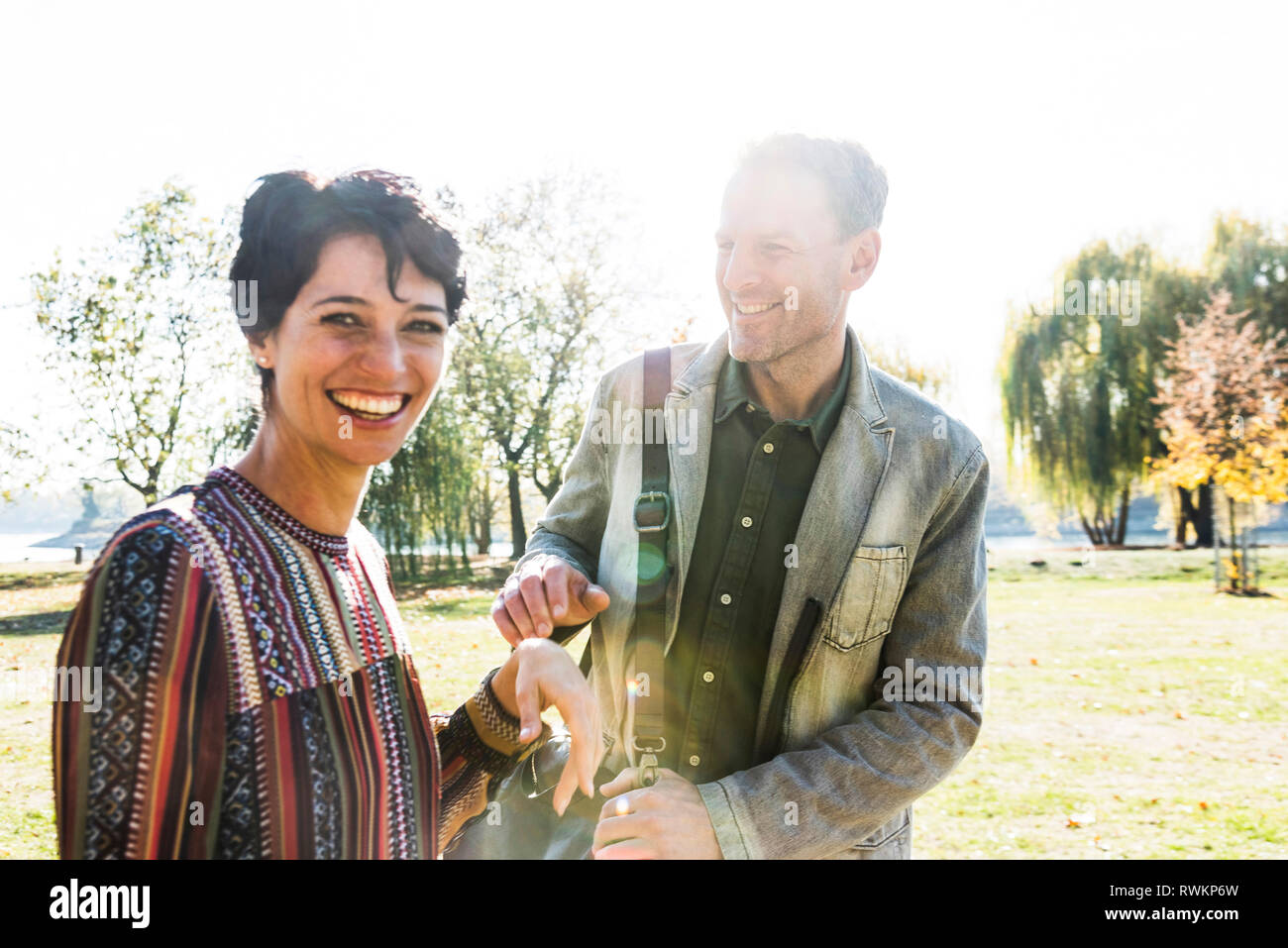 Couple teasing each other in park, Strandbad, Mannheim, Germany Stock Photo