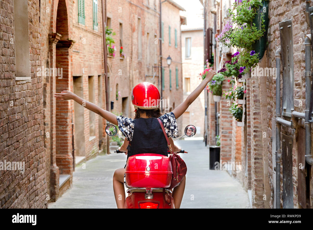 Woman exploring on scooter, Città della Pieve, Umbria, Italy Stock Photo