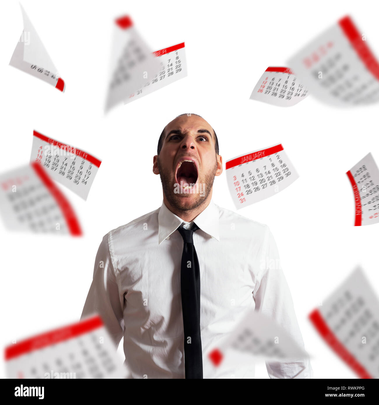 Businessman stressed and overworked screaming in office with flying paper sheets Stock Photo