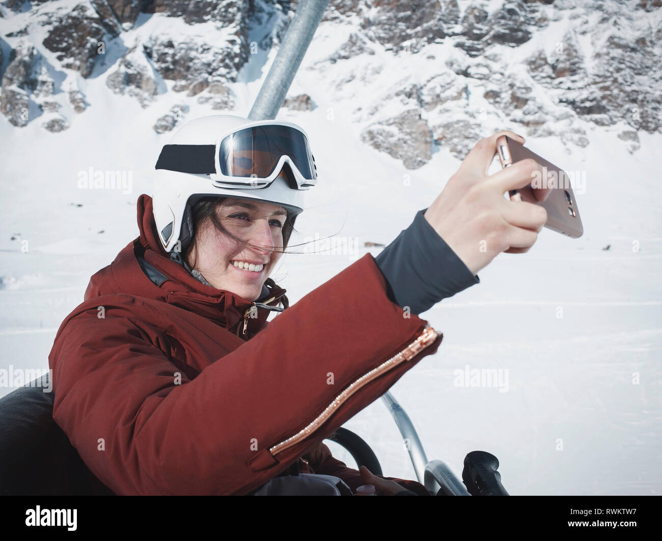 Young woman skier wearing helmet and ski goggles taking selfie on ski lift,  Alpe Ciamporino, Piemonte, Italy Stock Photo - Alamy