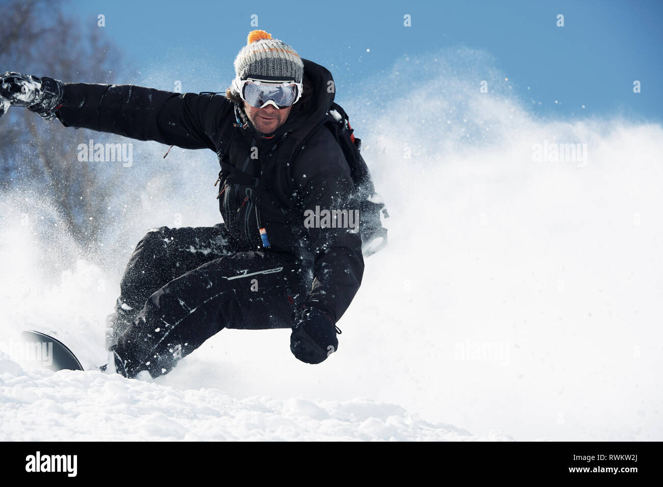 Male snowboarder speeding down mountainside, Alpe-d'Huez, Rhone-Alpes, France Stock Photo