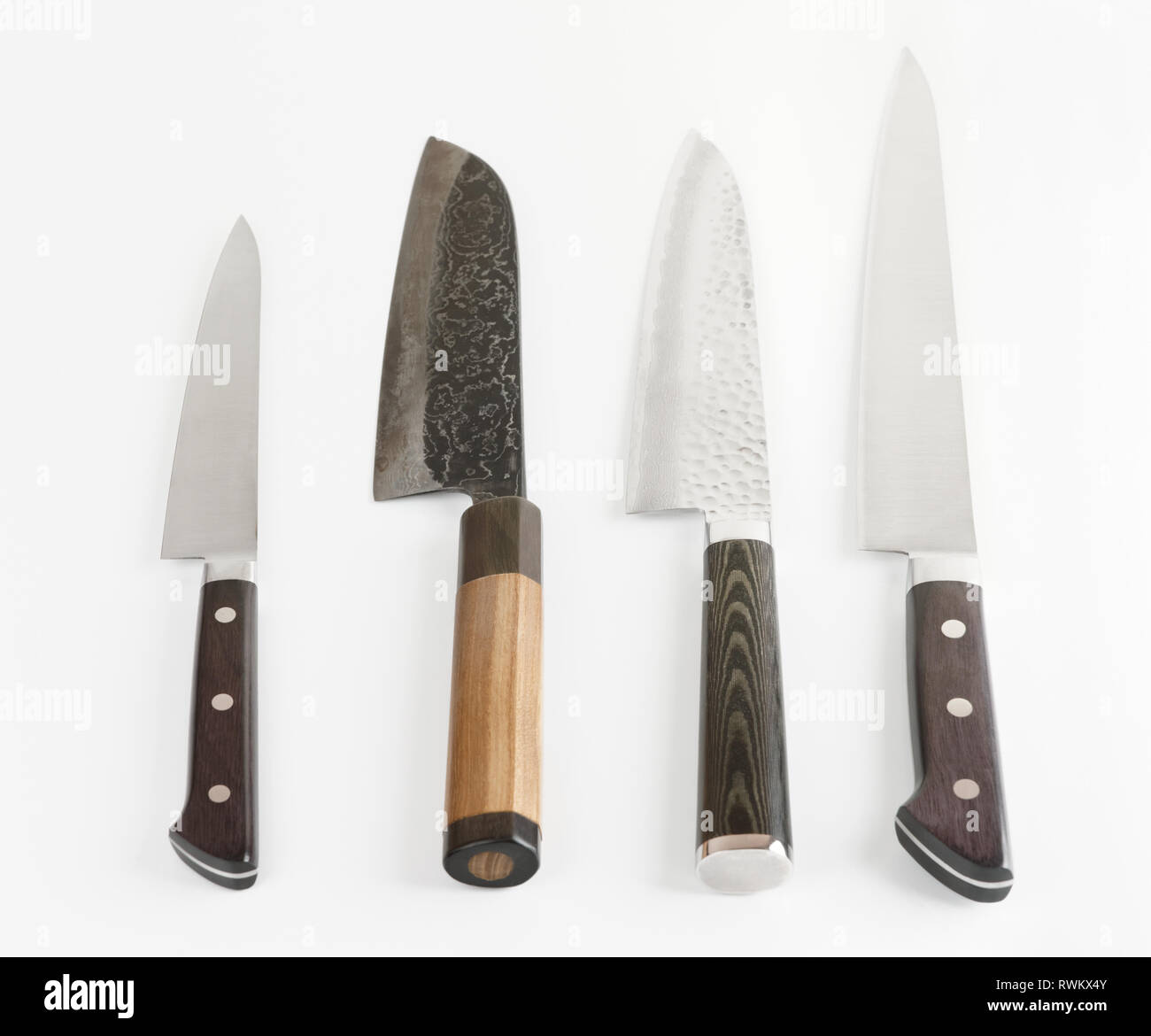Four different knives shot on light gray surface with smooth shadows Stock Photo