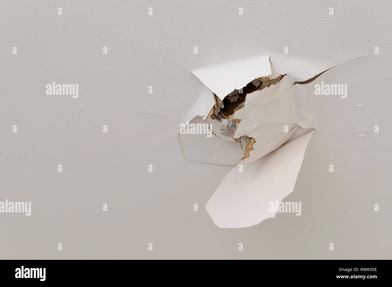 Plasterboard ceiling damaged with hole Stock Photo Alamy