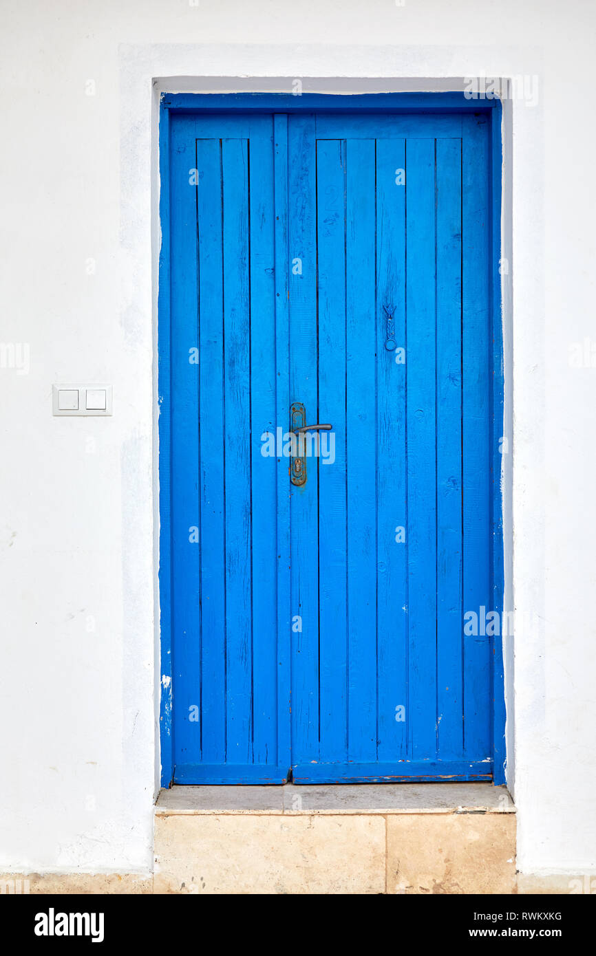 Old blue wooden door of a traditional Mediterranean house painted in ...