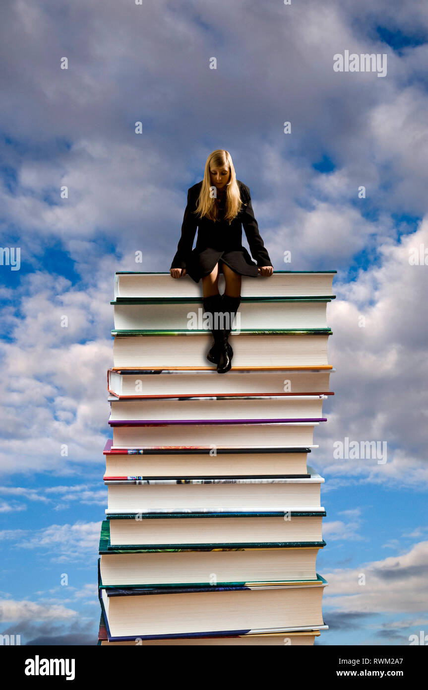Woman sitting on stack books hi-res stock photography and images - Alamy