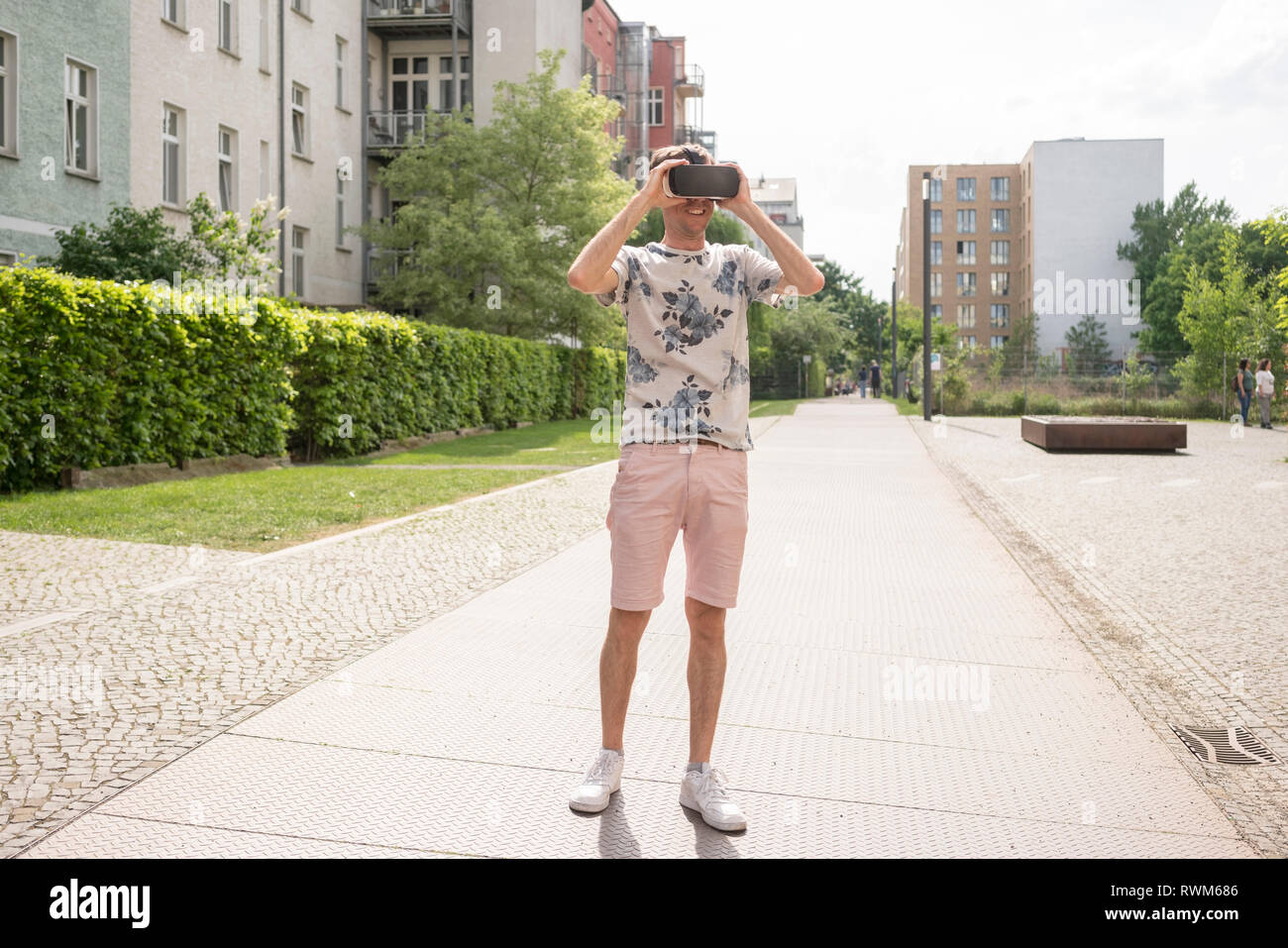 Man using virtual reality goggles in urban Berlin, Germany Stock Photo
