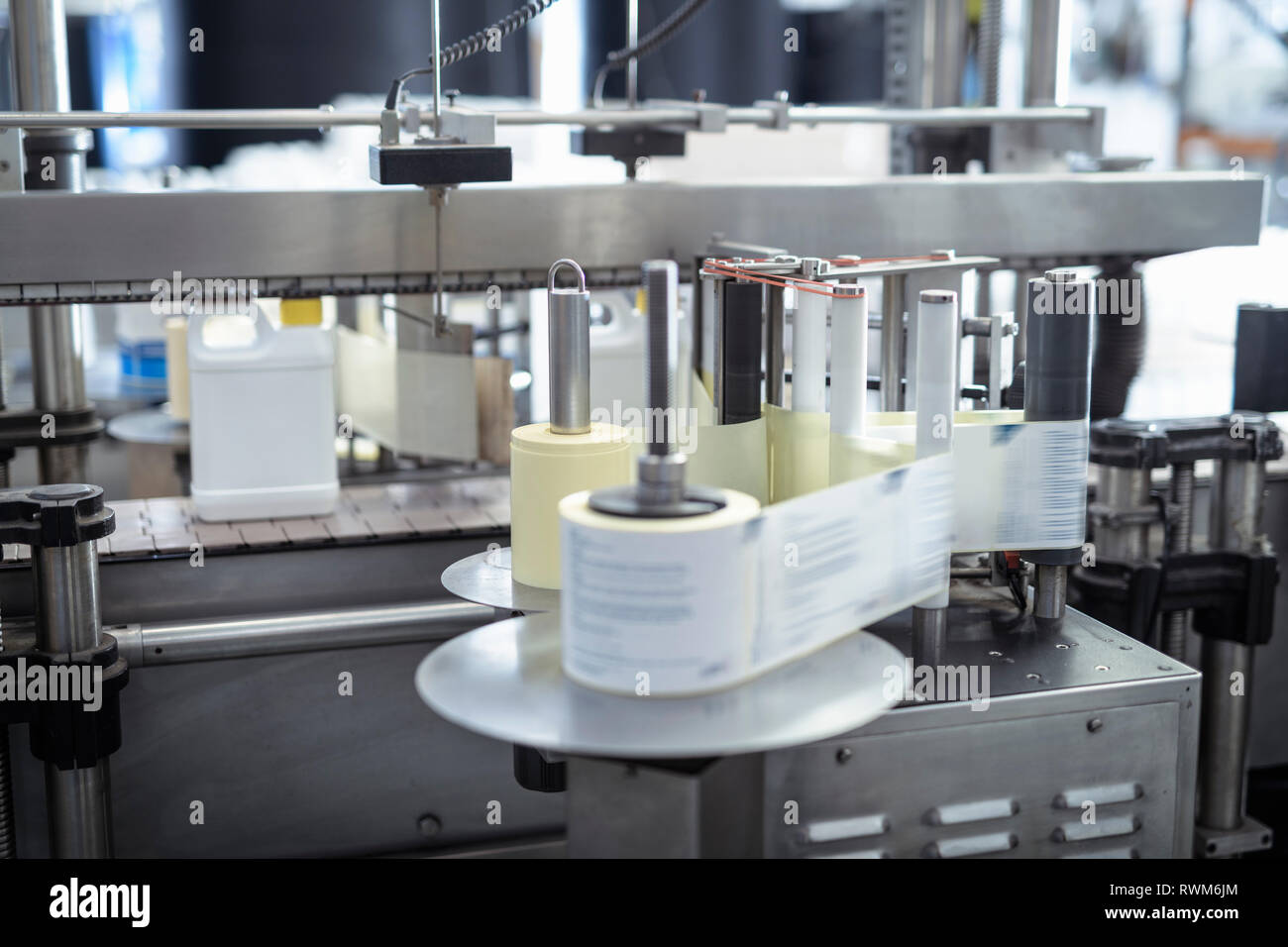 Labelling machine in chemical factory Stock Photo