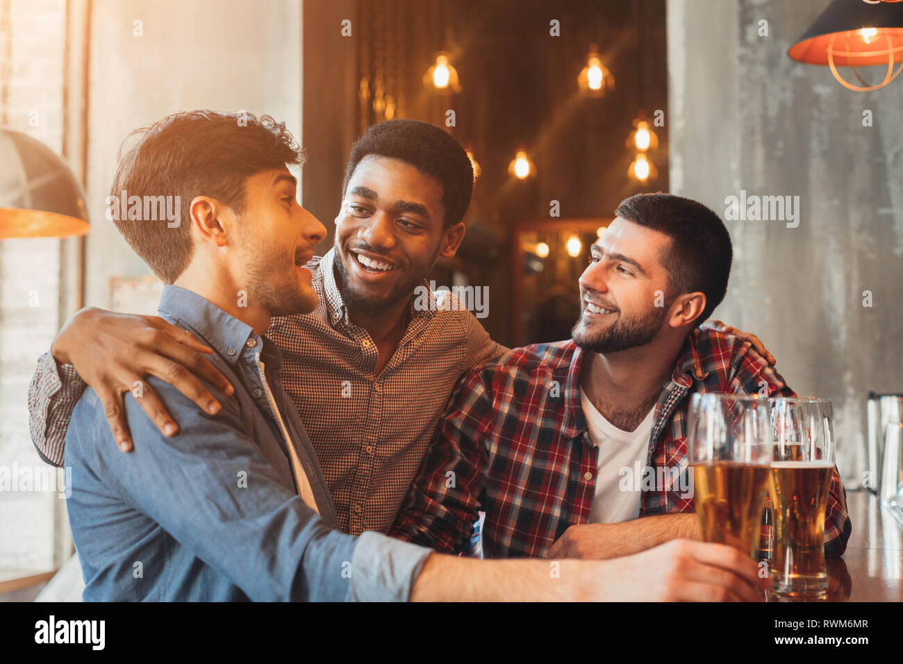 Beer Meating Best friends drinking beer, meeting in pub Stock Photo - Alamy