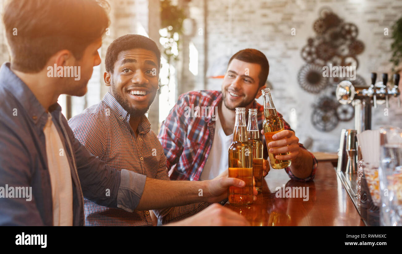 Guys drinking beer for meeting in bar Stock Photo Alamy