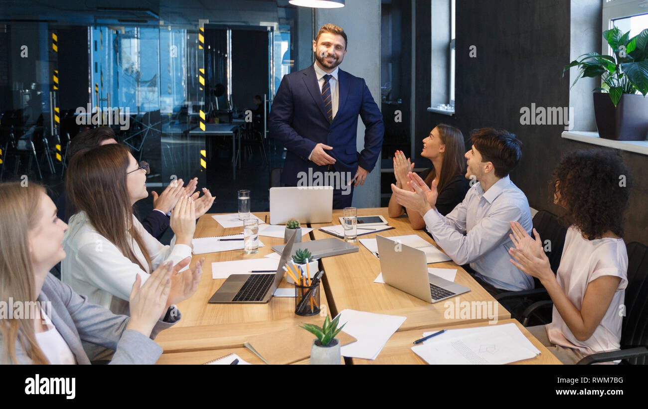 Business team applauding to leader, congratulating with project Stock Photo