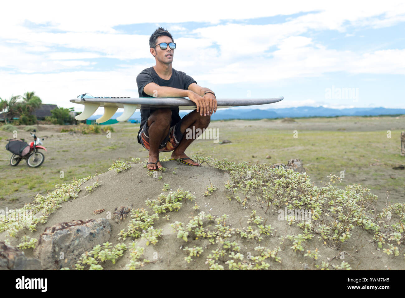 Surfer with surfboard on beach, Abulug, Cagayan, Philippines Stock ...