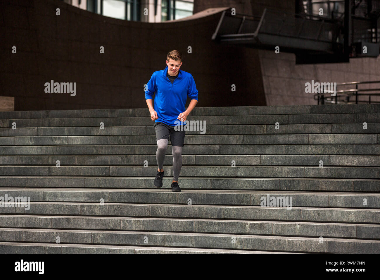 Young runner jogging down steps, London, UK Stock Photo