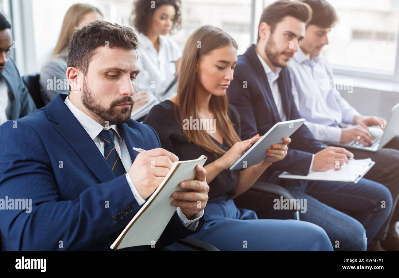 Business training, people making notes at seminar Stock Photo
