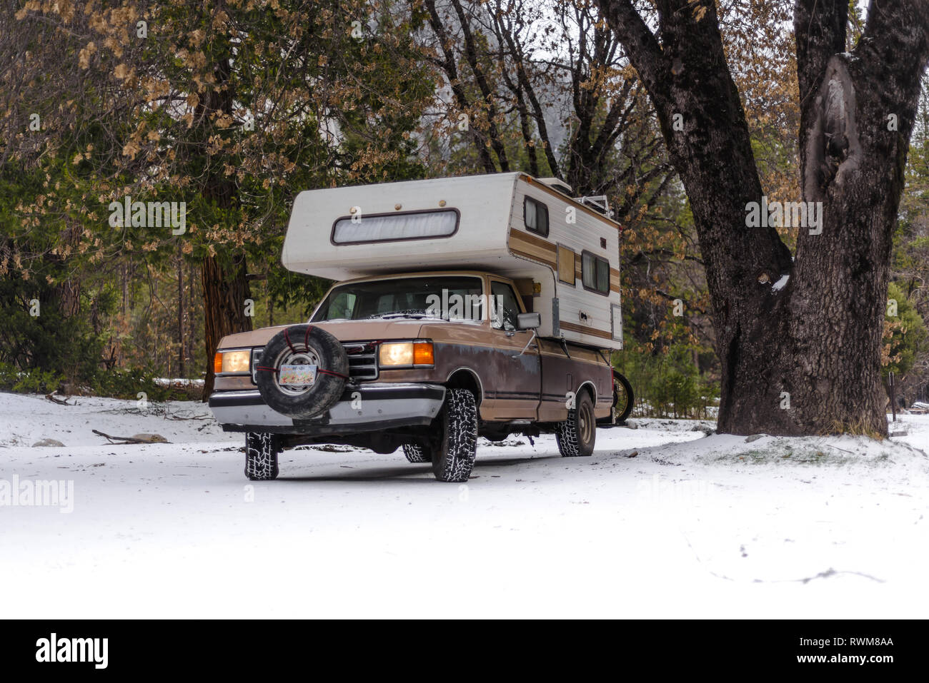 Campervan parked on snow covered ground, Yosemite National Park, California, USA Stock Photo