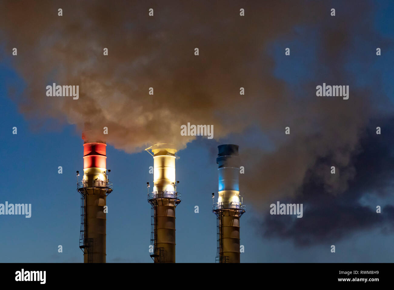 Dearborn, Michigan - Red, white, and blue smokestacks at the Dearborn Industrial Generation facility. The plant burns natural gas and waste blast furn Stock Photo
