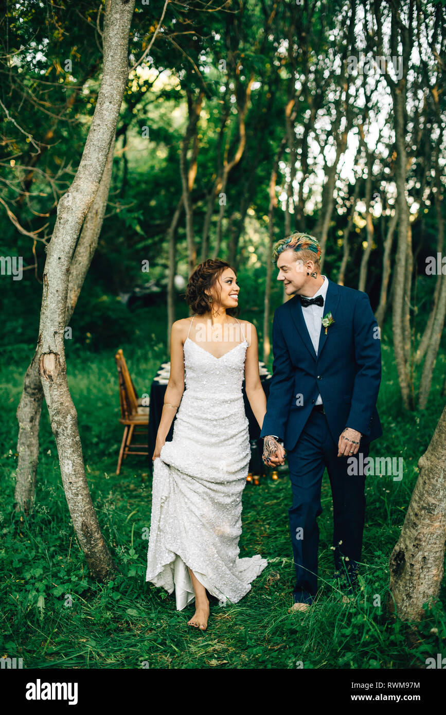 Romantic bride and groom strolling in forest Stock Photo - Alamy