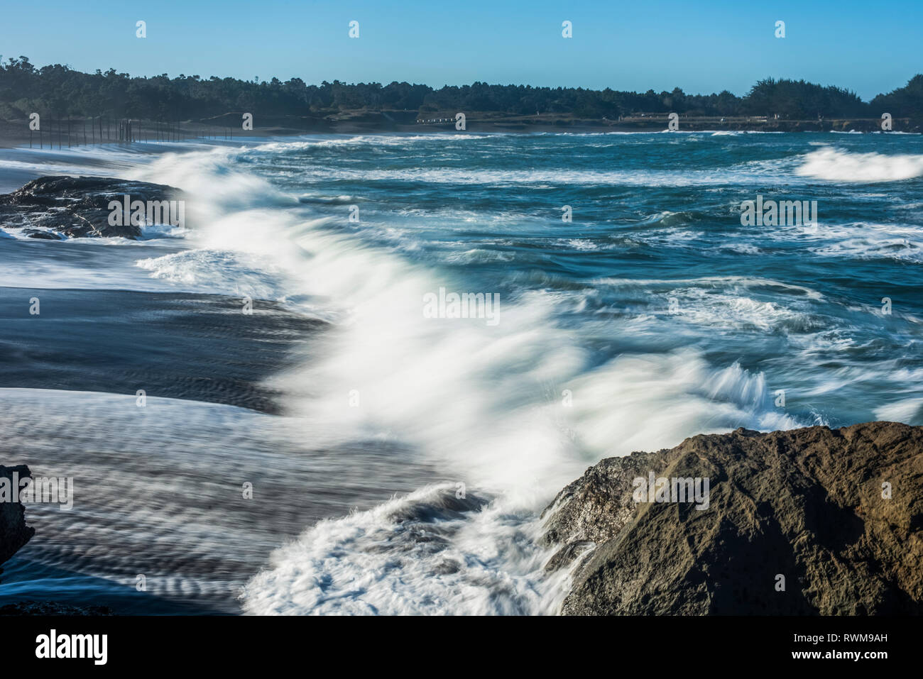 Waves softened by a long exposure surge onto the beach at MacKerricher State Park and Marine Conservation Area near Cleone in Northern California Stock Photo