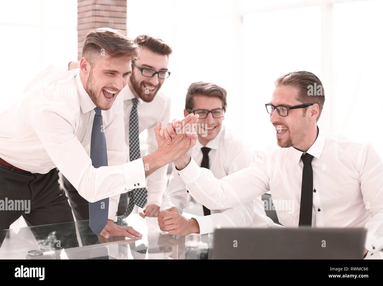 employees giving each other a high five Stock Photo - Alamy