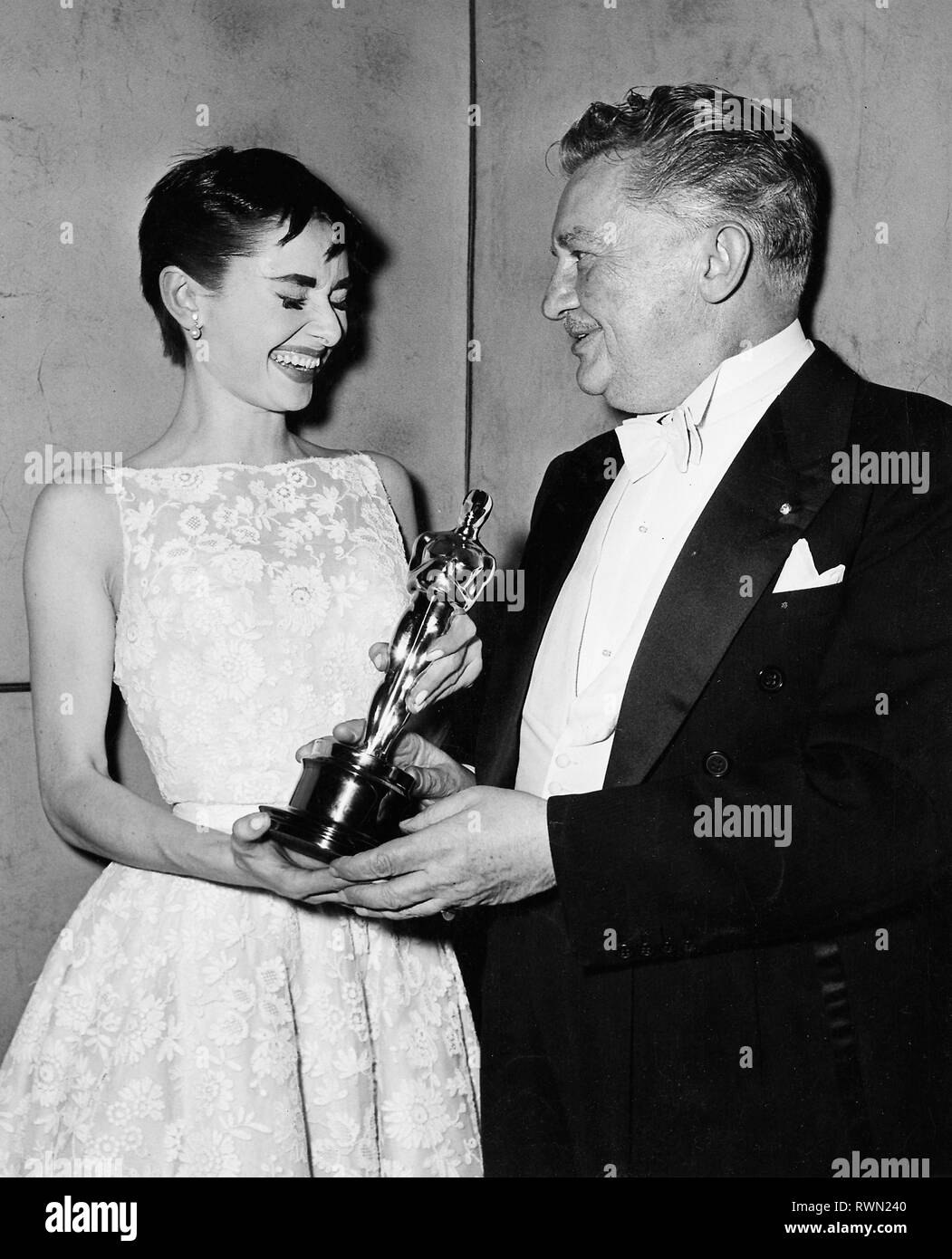 Audrey Hepburn wearing a white floral dress by Hubert de Givenchy and Jean  Hersholtz, the 26th Annual Academy Awards held at the NBC Century Theatre  in New York City on March 25,