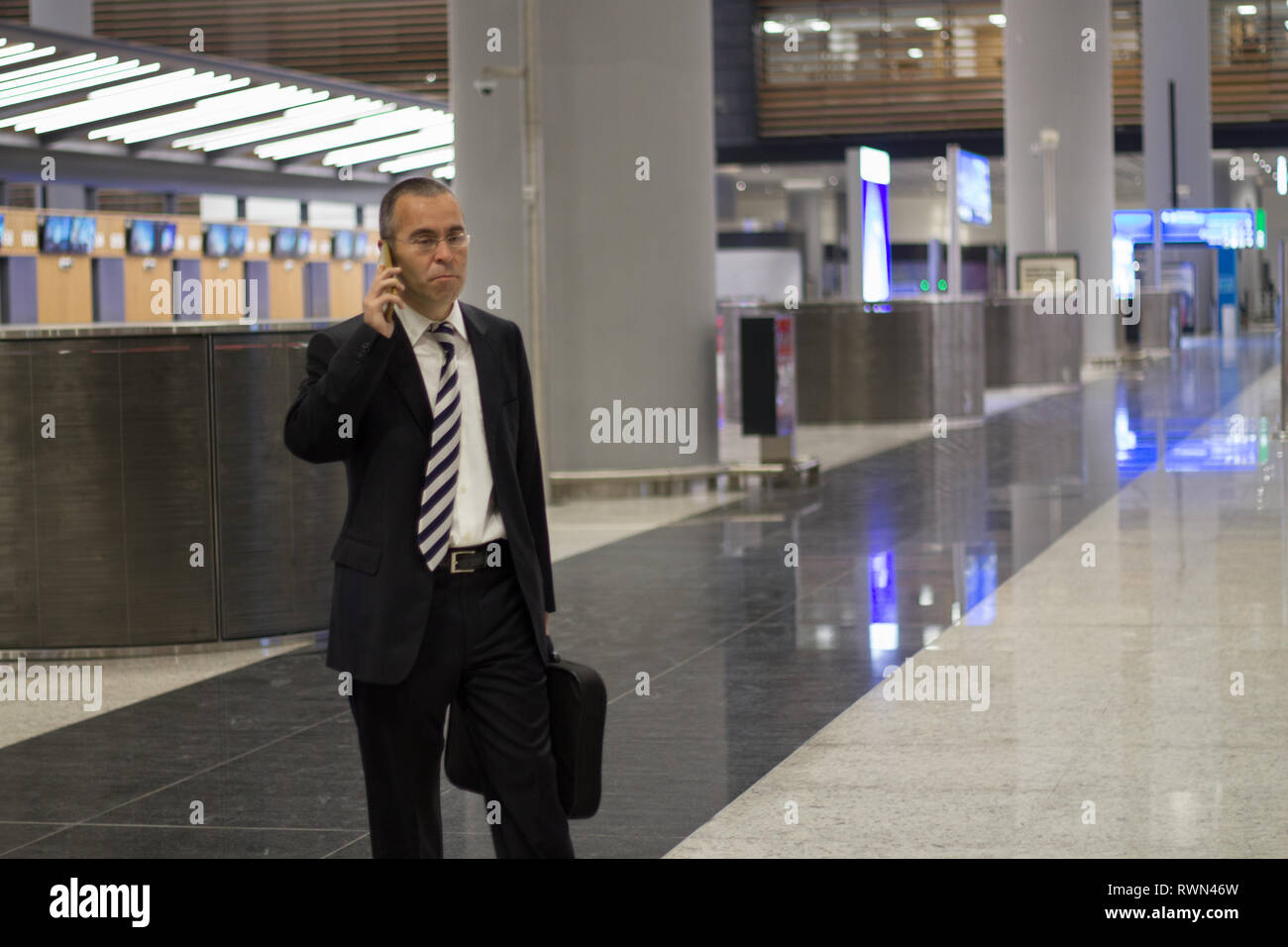 Passenger business man at the airport talking with phone Stock Photo