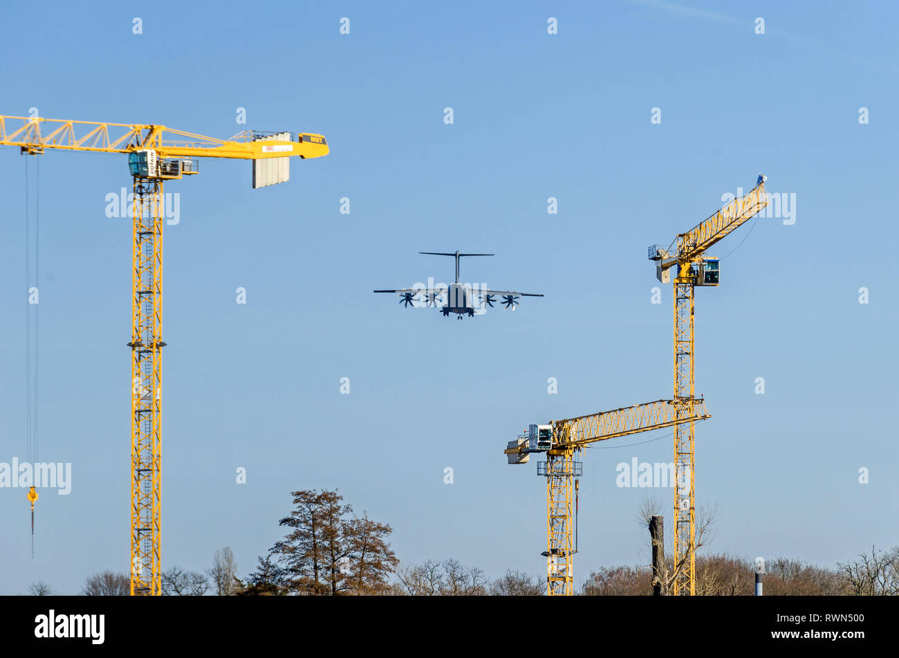 Berlin, Germany - February 22, 2019: Four-engine turboprop military transport aircraft (presumably Airbus A-400M Atlas) heading the landing strip Stock Photo