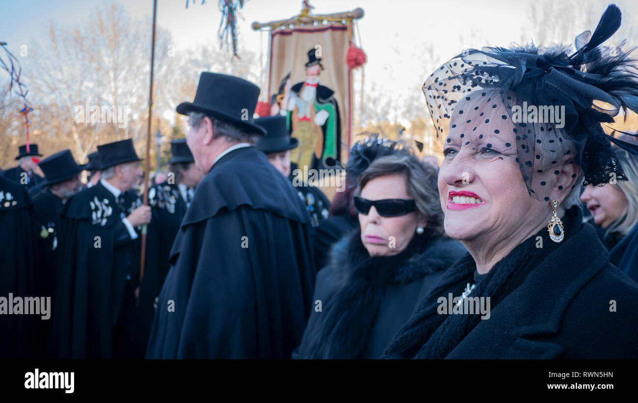 Women seen dressed like widows mourning for the sardine during the event. The traditional “Burial of the Sardine” is a ceremony that takes place in Madrid to mark the end of Carnival celebrations and beginning of 40 days Lent before Easter. It consists of a parade that parodies a funeral in which a symbolic figure in the shape of a sardine is burned. This festivity coincides with Ash Wednesday and symbolizes the burial of the past and the rebirth of society. Stock Photo