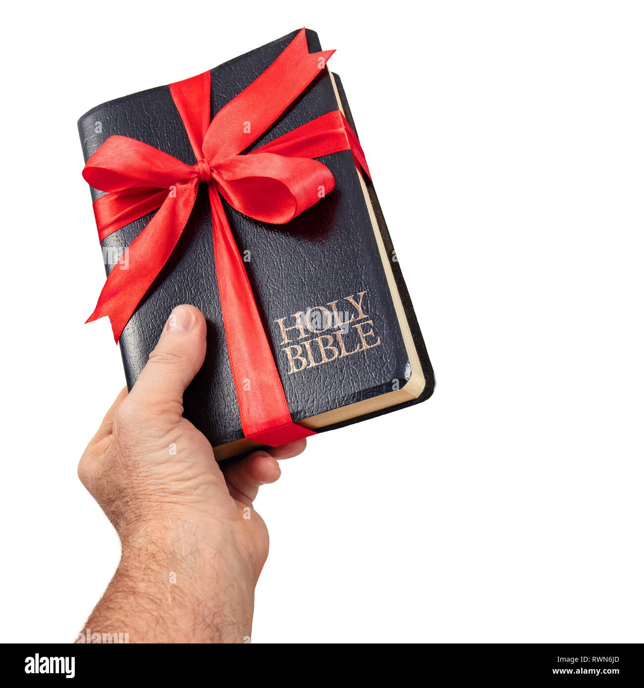 Hand giving the Holy Bible gift isolate on white backround Stock Photo