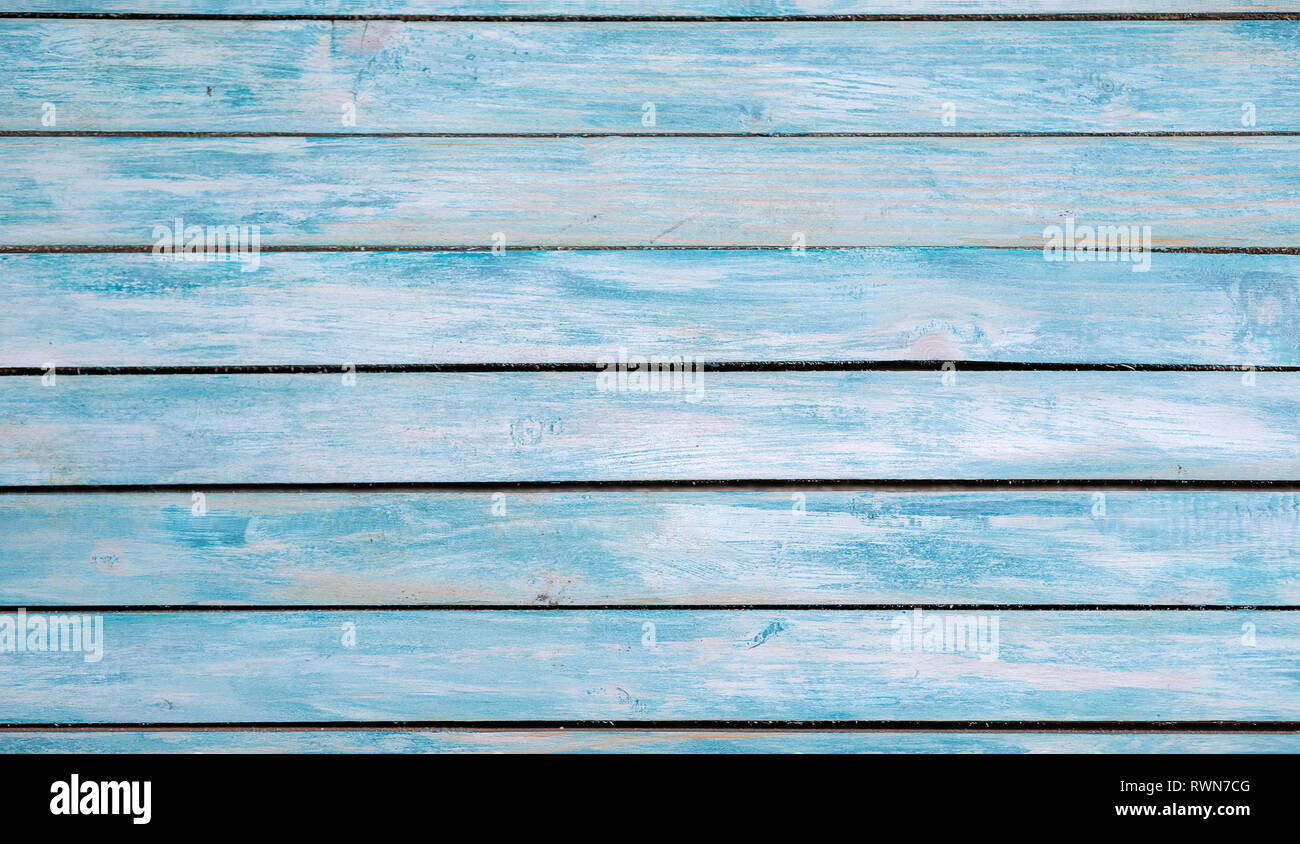 Turquoise bright colored old vintage wood table with horizontal boards. Grunge wooden background. Shabby chic France Provence style. Green blue sea co Stock Photo