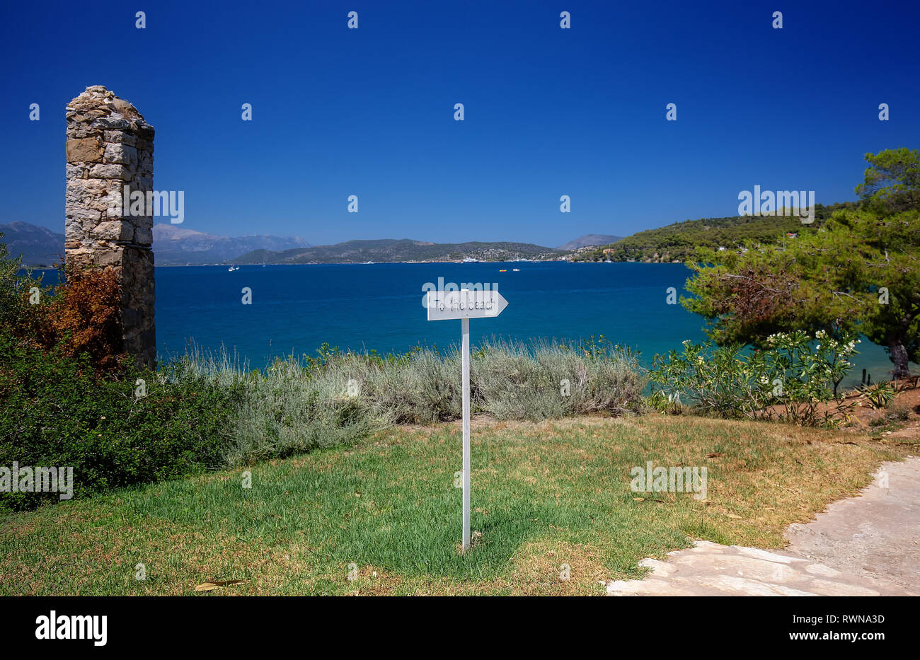 Travel Greece. To the beach sign. Spectacular view on one of the most beautiful beaches in Poros Island. Summer holiday Stock Photo