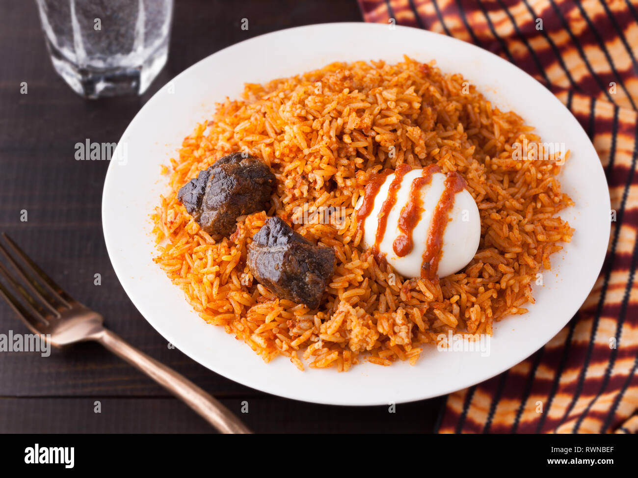 West African Rice Jollof with Beef and Boiled Egg with Shito sauce ...