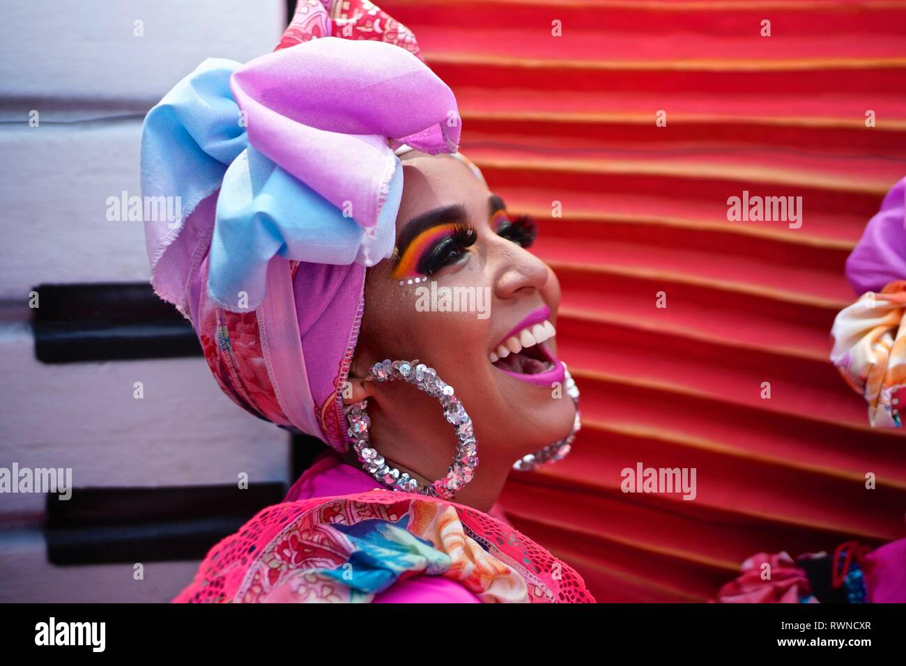 Dancer wearing a colorful headdress at the Battle of Flowers Stock Photo