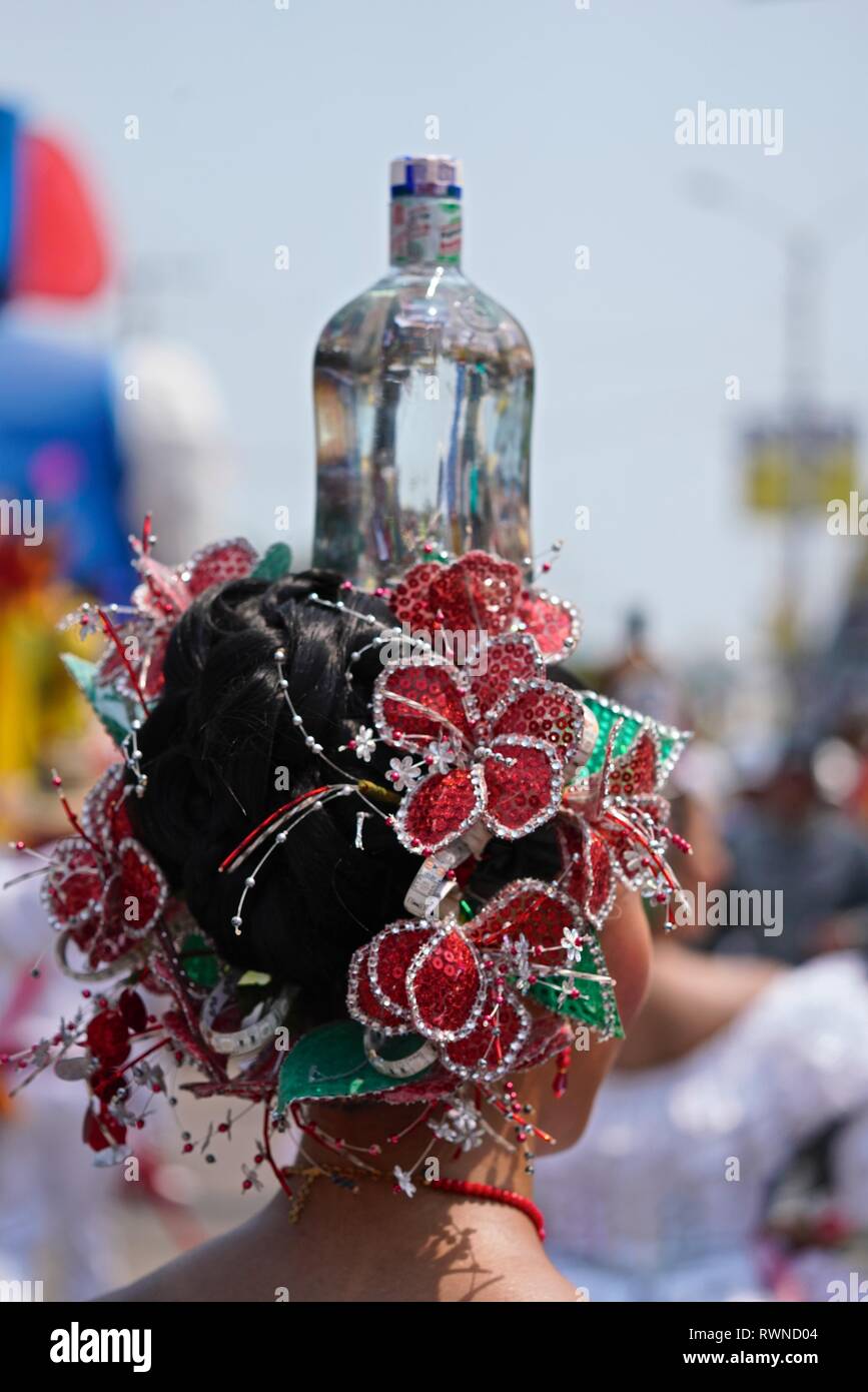 Colombian cumbia dancers balancing a glass bottle on her heads Stock Photo