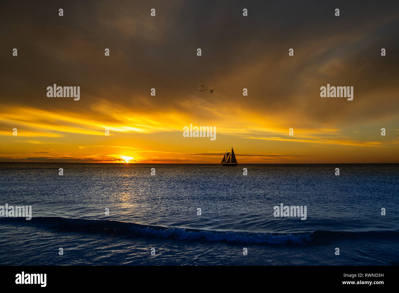 Sunset with silhouetted ship Stock Photo - Alamy