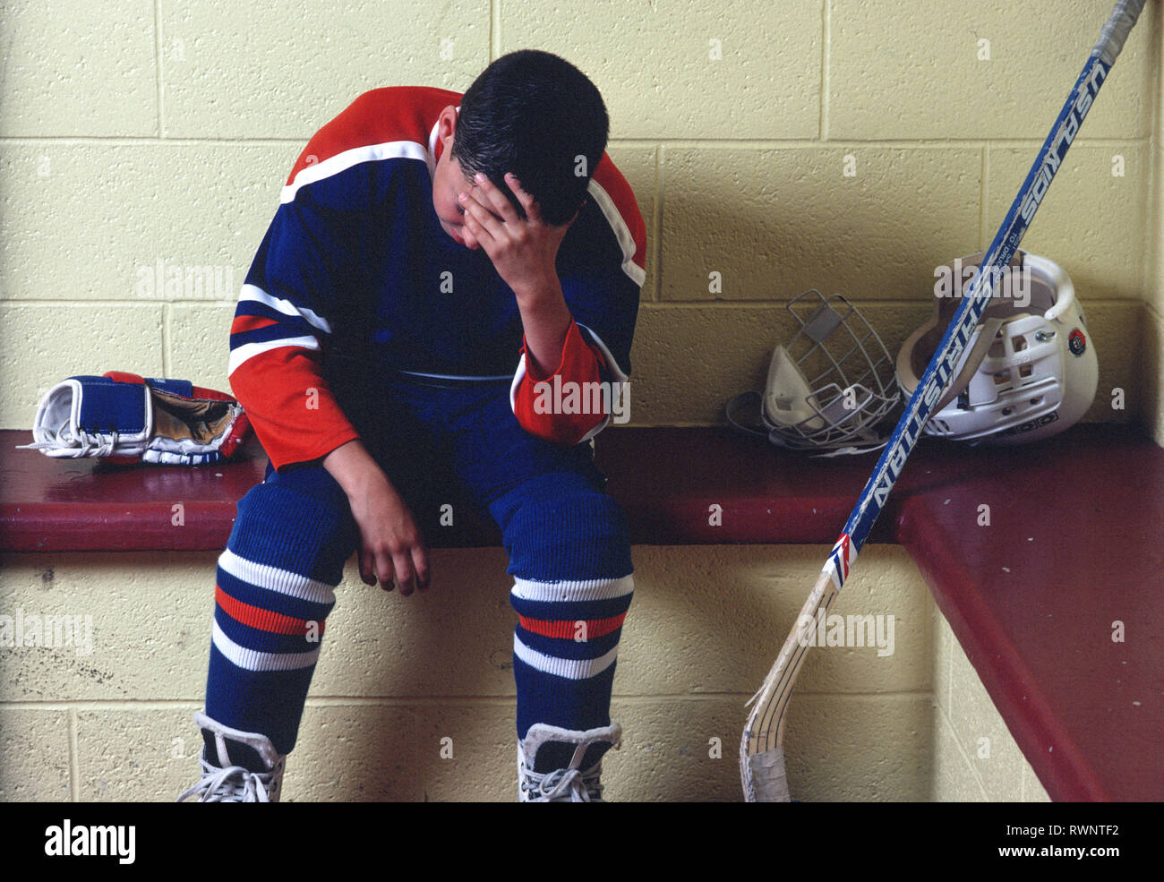 Hockey Player in Locker room after Losing Game, 1990s, USA Stock Photo