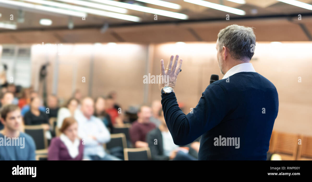 Expert giving a talk on business conference workshop. Unrecognizable ...