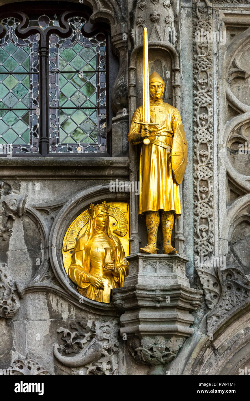 Close-up of a gold statue on a decorative building facade; Bruges, Belgium Stock Photo