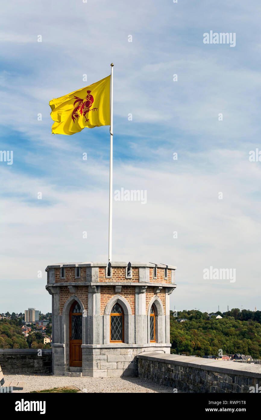 Close-up of castle turret with flag waving on pole with blue sky and clouds; Namur, Belgium Stock Photo