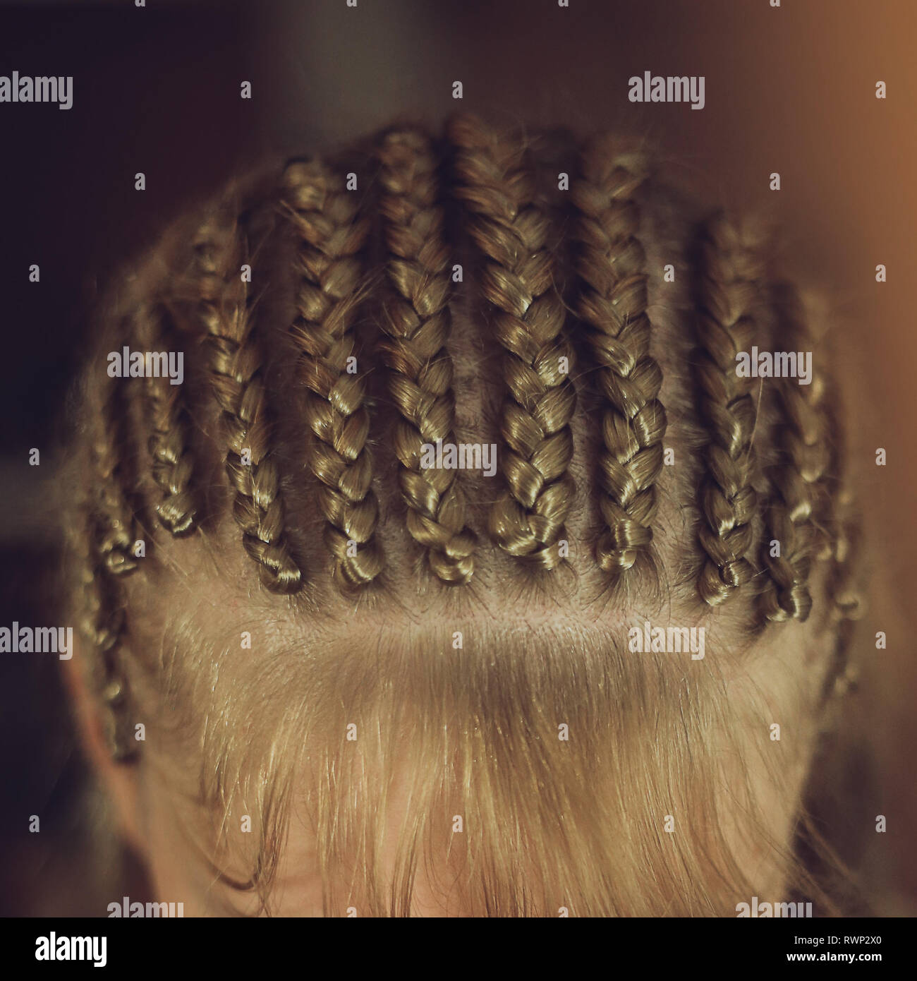 thick braids close up in African style on the girl's head, bangs, hairstyle, hair braided Stock Photo