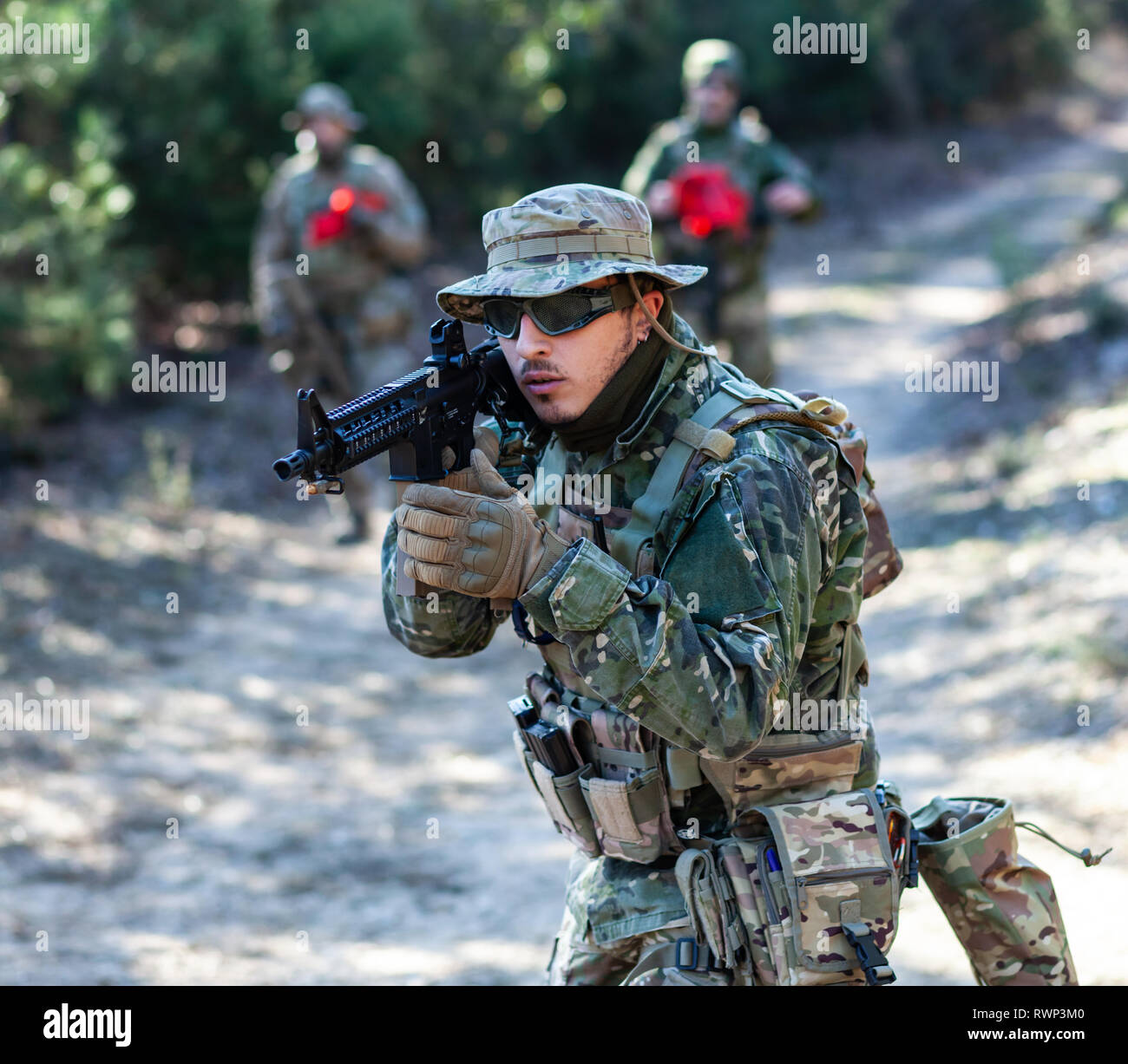Airsoft military game player in camouflage uniform with armed assault rifle  Stock Photo - Alamy