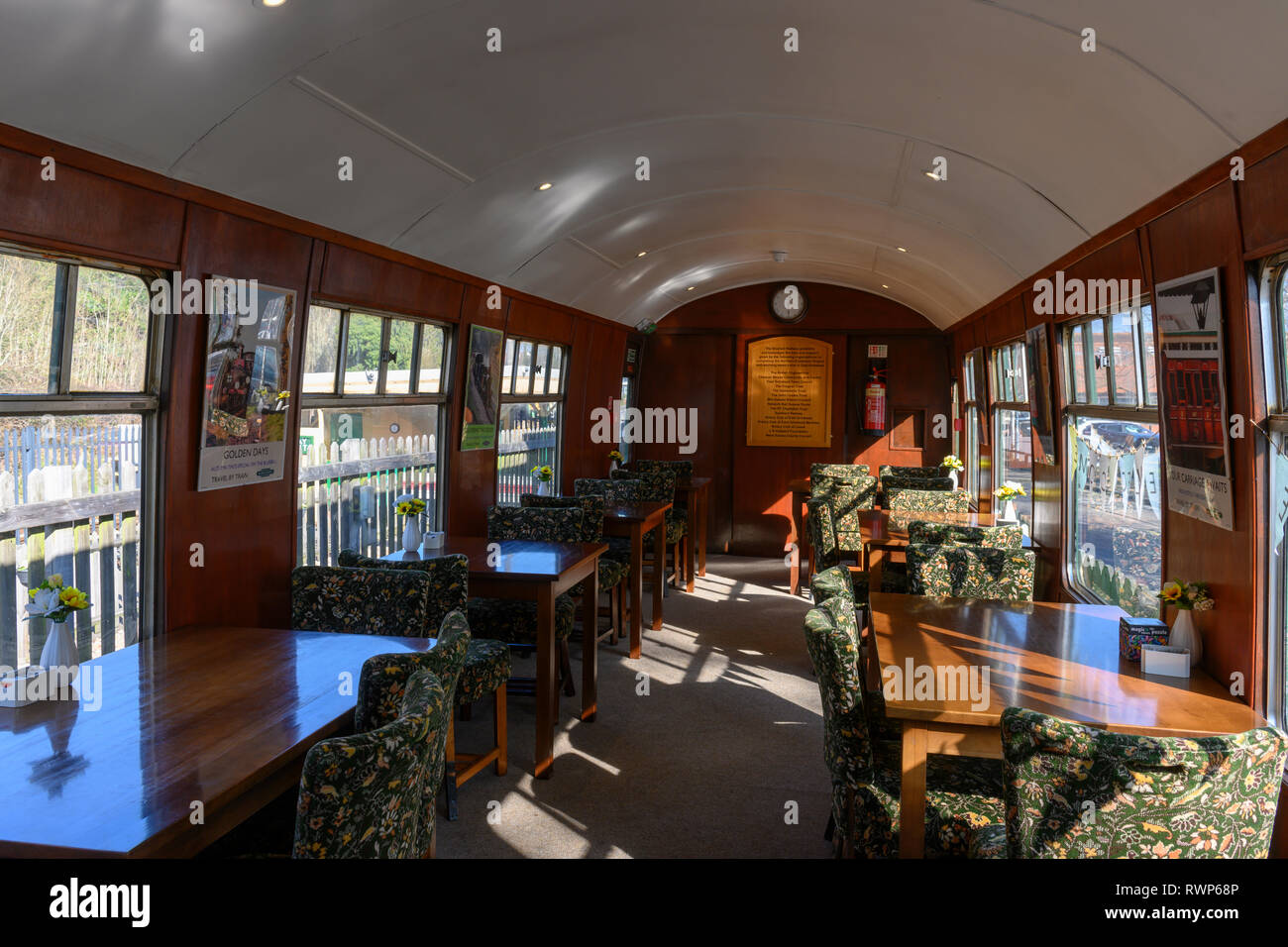 Interior of an old passenger train carriage used as a tea room on the Bluebell Railway at East Grinstead Railway Station, West Sussex, UK. Stock Photo