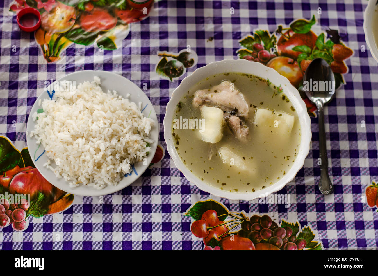 Traditional Panamanian food known as 'Sancocho' or chicken soup accompanied with 'arroz blanco'  or white rice, served as usual. Stock Photo