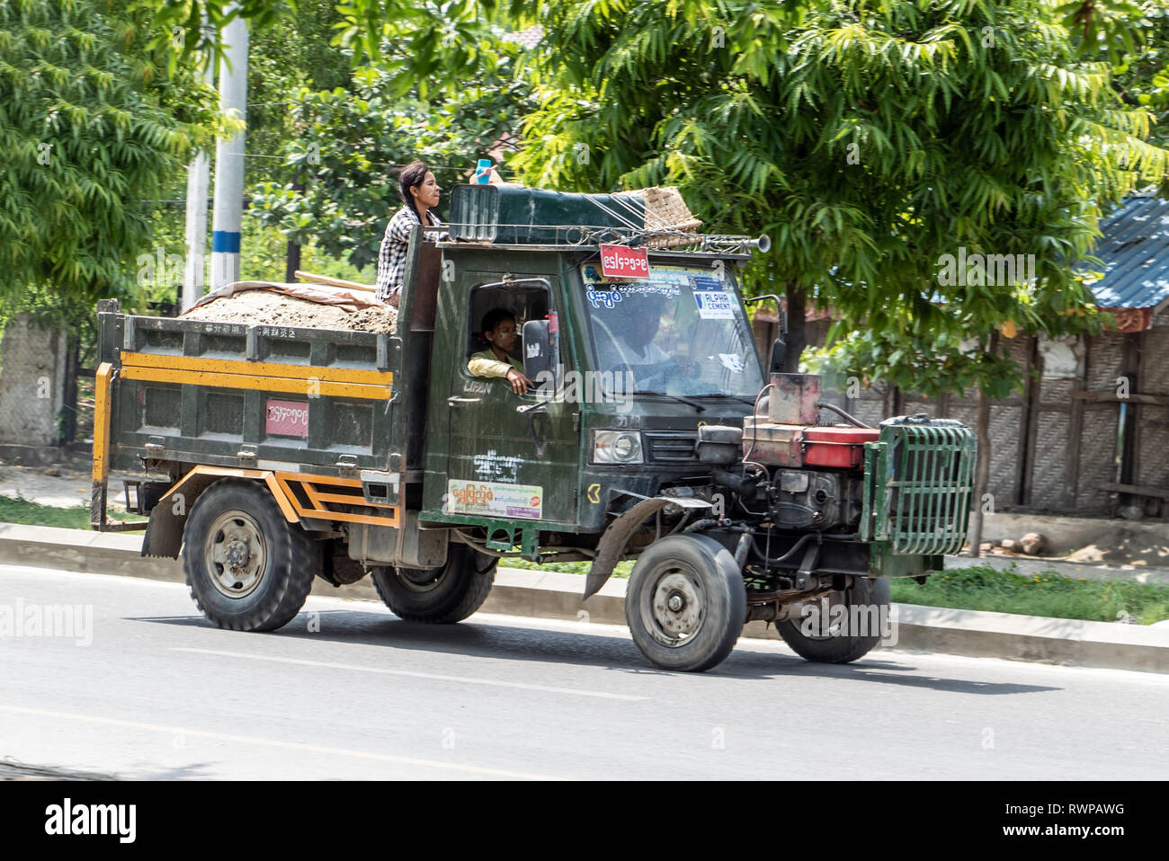 MYANMAR, MANDALAY, MAY 20 2018, Chinese Manufactured tractor truck ride on street at Mandalay city. Typical open-fronted battered lorry vehicle with a Stock Photo