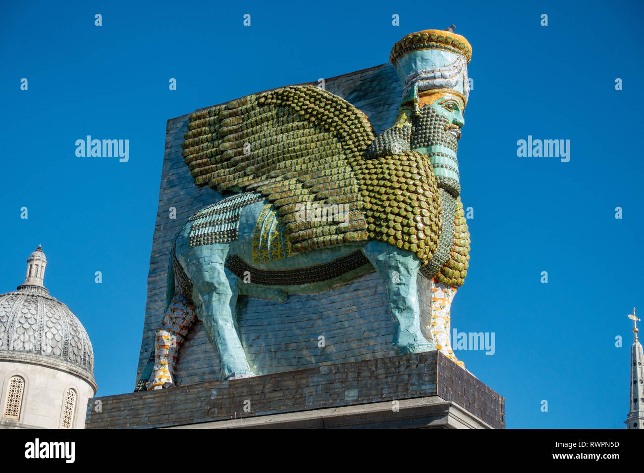 Side on view looking at Trafalgar Square’s, fourth plinth, Winged Bull, a guardian spirit that protected the gates of the Assyrian city of Nineveh for Stock Photo