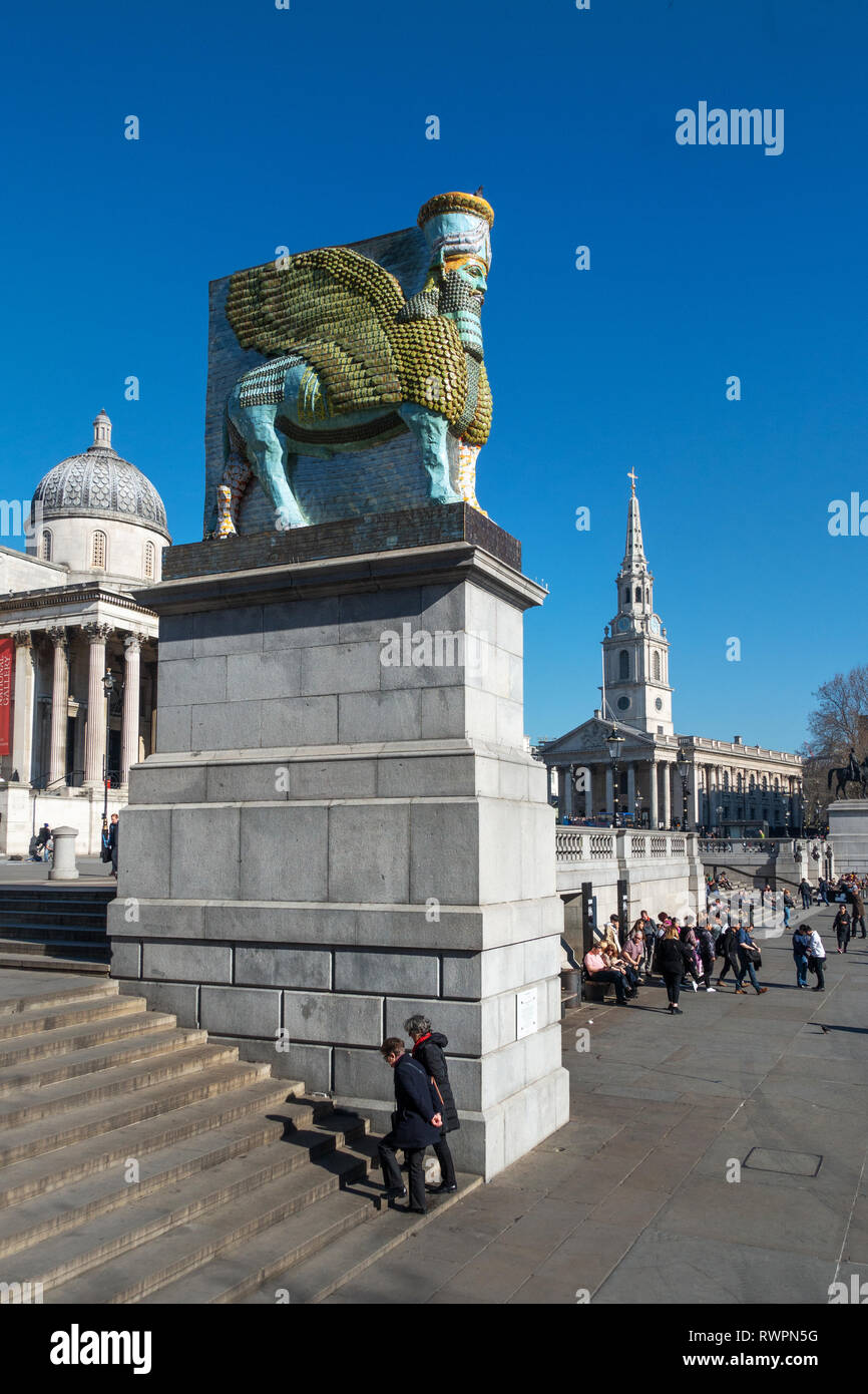 Side on view looking at Trafalgar Square’s, fourth plinth, Winged Bull, a guardian spirit that protected the gates of the Assyrian city of Nineveh for Stock Photo